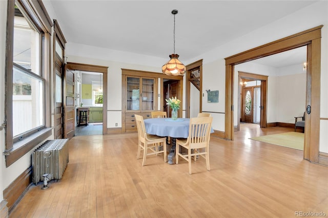 7011 Grandview Ave, Arvada, CO 80002 - dining room featuring radiator heating unit and light wood-type flooring