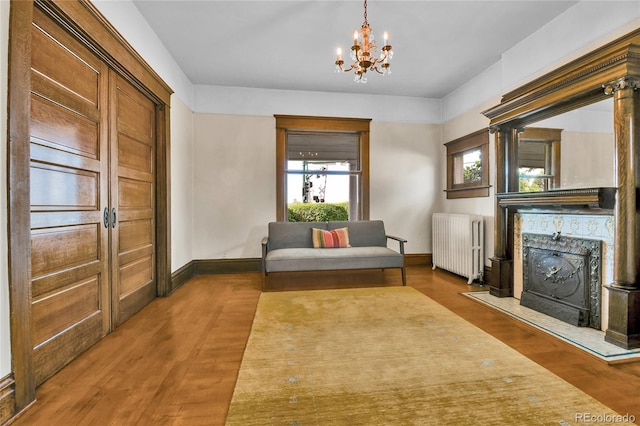 7011 Grandview Ave, Arvada, CO 80002 - sitting room with radiator heating unit, a chandelier, and wood finished floors