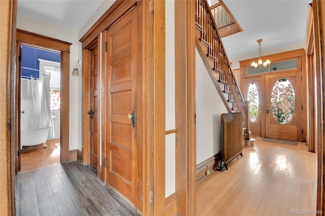 7011 Grandview Ave, Arvada, CO 80002 - foyer entrance featuring a chandelier, hardwood / wood-style flooring, and stairway