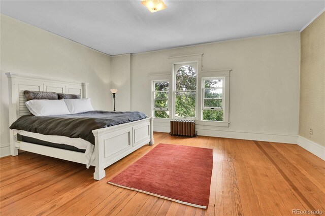 7011 Grandview Ave, Arvada, CO 80002 - bedroom featuring radiator and light wood-style floors