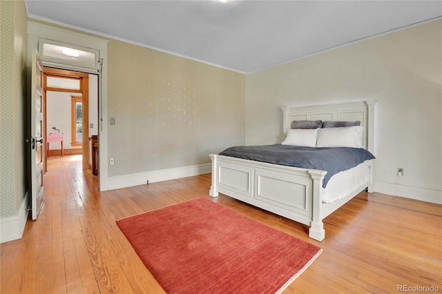 7011 Grandview Ave, Arvada, CO 80002 - bedroom featuring ornamental molding and light wood finished floors