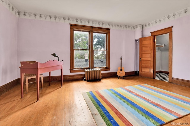 7011 Grandview Ave, Arvada, CO 80002 - sitting room featuring radiator heating unit and light wood-style flooring