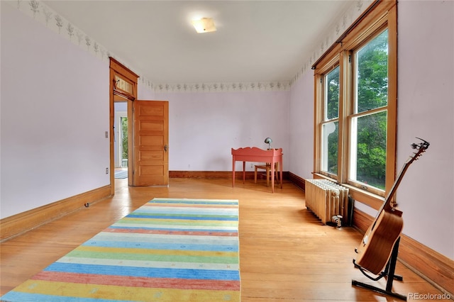 7011 Grandview Ave, Arvada, CO 80002 - recreation room featuring radiator and light wood-style floors