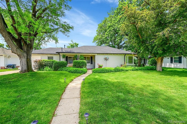 1935 Oneida St, Denver, CO 80220 - ranch-style house featuring a front yard, stucco siding, and a garage