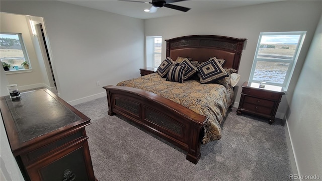 bedroom featuring dark carpet, multiple windows, and ceiling fan