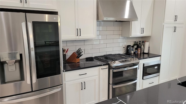 kitchen featuring white cabinets, stainless steel appliances, tasteful backsplash, and wall chimney range hood