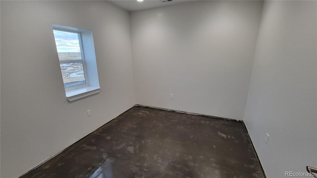 spare room featuring concrete flooring