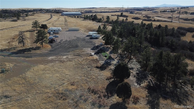 birds eye view of property with a rural view