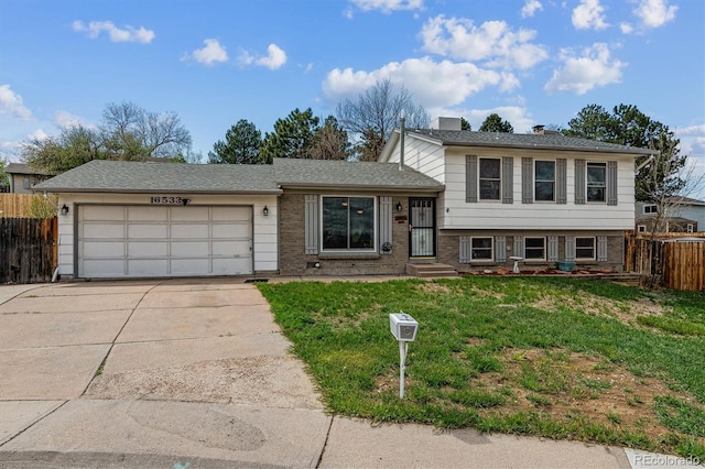 16533 E Baker Pl, Aurora, CO 80013 - tri-level home featuring a garage, concrete driveway, and brick siding