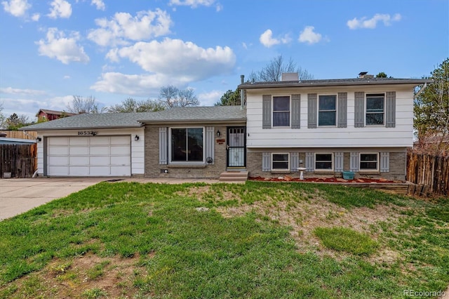 16533 E Baker Pl, Aurora, CO 80013 - split level home featuring a garage, concrete driveway, and brick siding