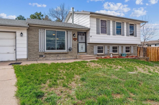 16533 E Baker Pl, Aurora, CO 80013 - tri-level home featuring brick siding and an attached garage