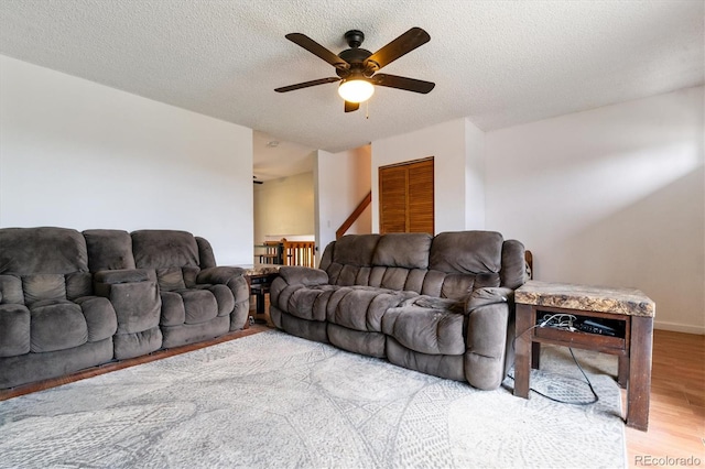 16533 E Baker Pl, Aurora, CO 80013 - living room featuring a ceiling fan, light wood finished floors, and a textured ceiling