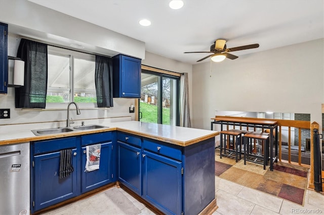 16533 E Baker Pl, Aurora, CO 80013 - kitchen with blue cabinets, dishwasher, ceiling fan, a peninsula, and light countertops