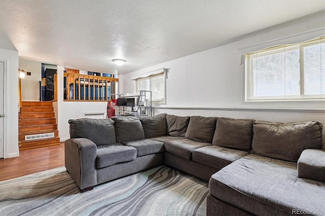 16533 E Baker Pl, Aurora, CO 80013 - living room with wood finished floors, stairway, and a textured ceiling