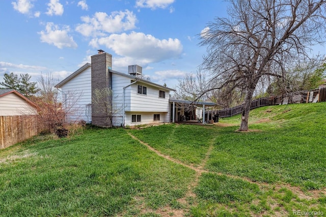 16533 E Baker Pl, Aurora, CO 80013 - back of house featuring a chimney and a fenced backyard