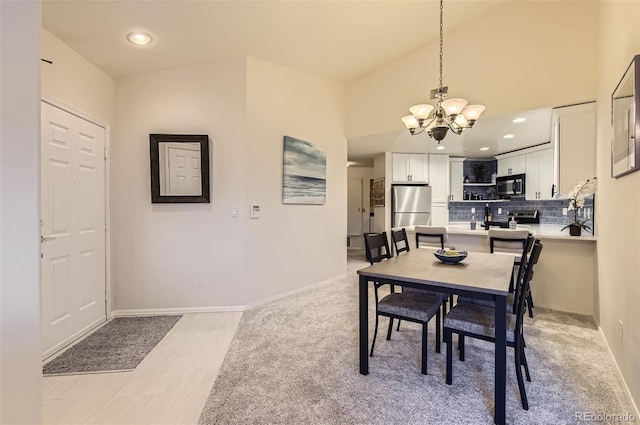 dining area with a chandelier and light wood-type flooring