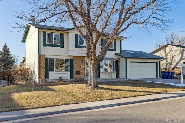 view of front facade with a garage and a front yard