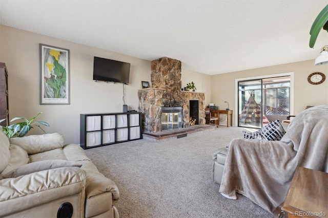 carpeted living room featuring a fireplace and a textured ceiling