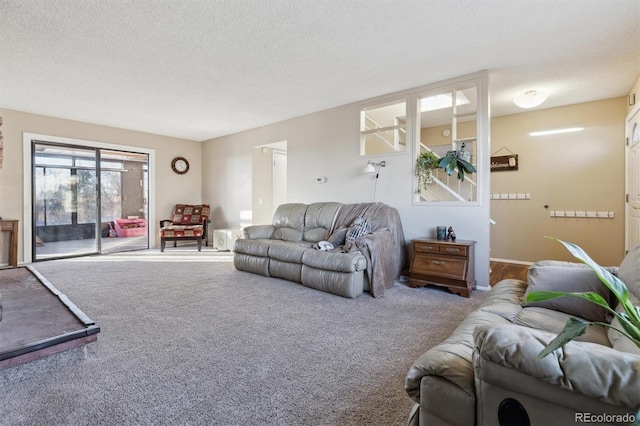 living room with a textured ceiling and carpet flooring