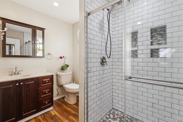 bathroom with vanity, hardwood / wood-style floors, an enclosed shower, and toilet