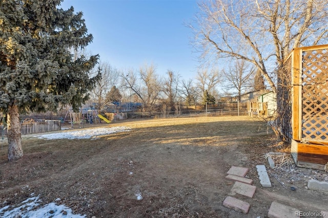 snowy yard with a playground