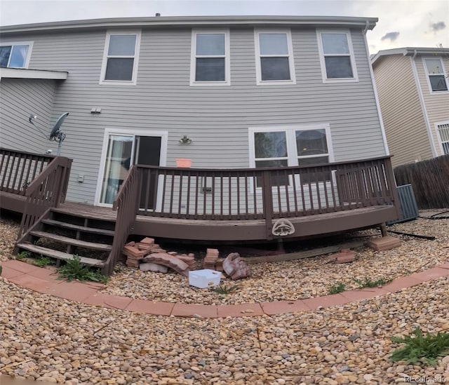 back of property with fence and a deck