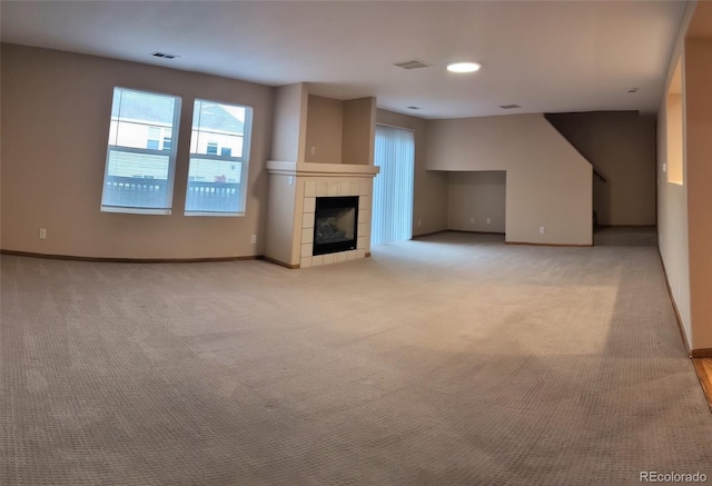 unfurnished living room featuring light carpet, baseboards, and visible vents