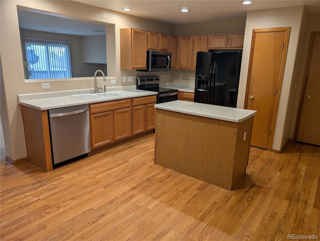kitchen featuring appliances with stainless steel finishes, recessed lighting, a sink, light countertops, and light wood-type flooring