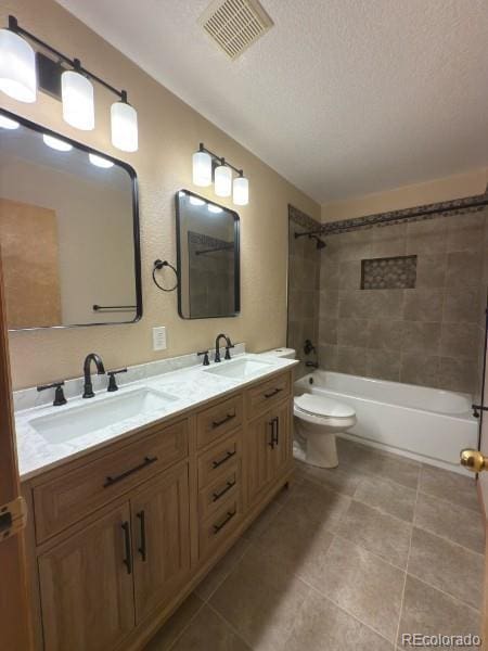 full bathroom with bathtub / shower combination, visible vents, a sink, and double vanity