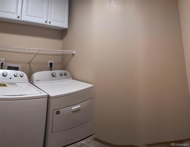 washroom with washer and dryer and cabinet space