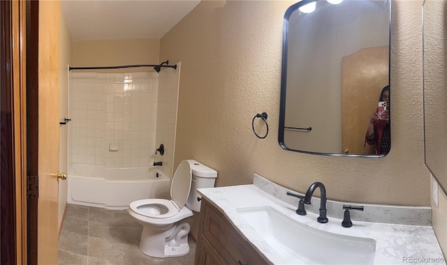 full bath with toilet, tile patterned flooring, vanity, and a textured wall