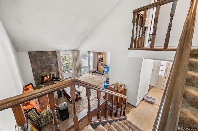 2742 S Xanadu Way, Aurora, CO 80014 - staircase featuring a fireplace and high vaulted ceiling