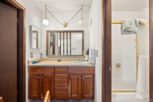2742 S Xanadu Way, Aurora, CO 80014 - bathroom with double vanity, a textured ceiling, and shower / bath combination