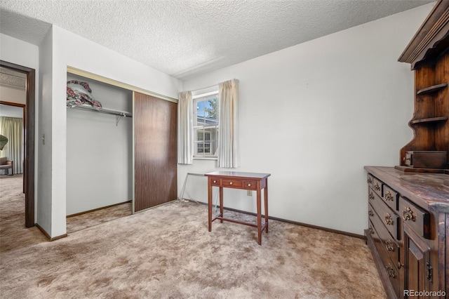 2742 S Xanadu Way, Aurora, CO 80014 - bedroom with light colored carpet, a closet, a textured ceiling, and baseboards