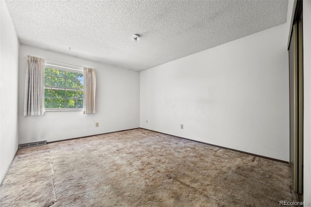2742 S Xanadu Way, Aurora, CO 80014 - spare room featuring carpet floors and a textured ceiling