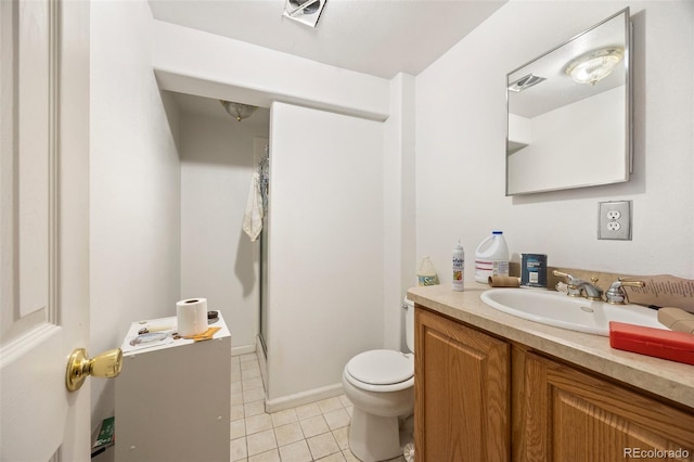 2742 S Xanadu Way, Aurora, CO 80014 - bathroom with vanity, toilet, tile patterned flooring, and a shower stall