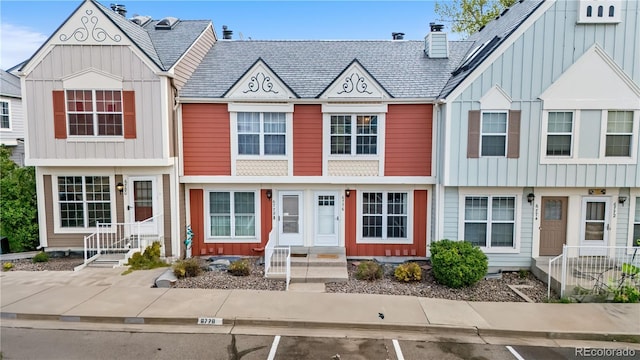 6776 S Independence St, Littleton, CO 80128 - multi unit property featuring uncovered parking, board and batten siding, and a chimney