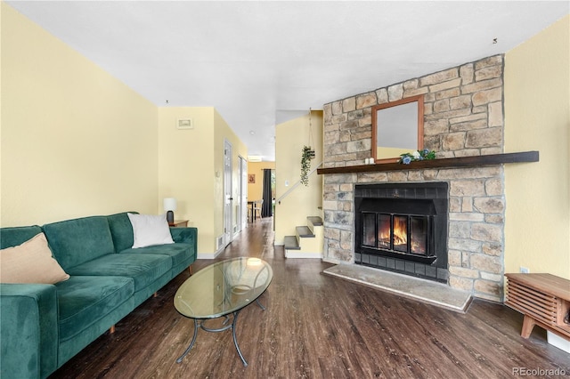 6776 S Independence St, Littleton, CO 80128 - living area featuring baseboards, a stone fireplace, and wood finished floors