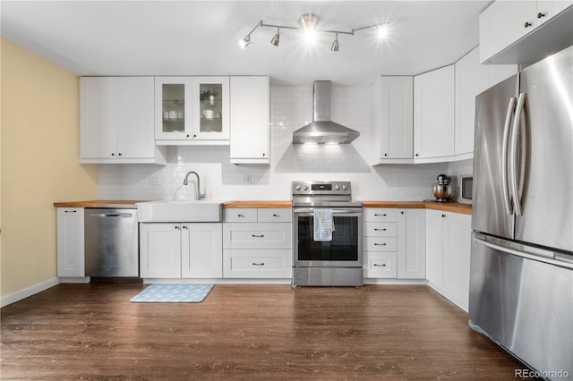 6776 S Independence St, Littleton, CO 80128 - kitchen featuring tasteful backsplash, a sink, wood counters, stainless steel appliances, and wall chimney exhaust hood