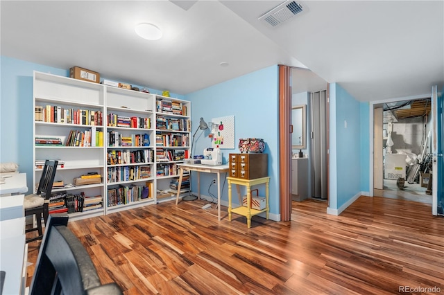 6776 S Independence St, Littleton, CO 80128 - office area featuring visible vents, baseboards, and wood finished floors