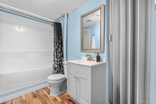 6776 S Independence St, Littleton, CO 80128 - bathroom with visible vents, shower / bath combination with curtain, wood finished floors, vanity, and toilet