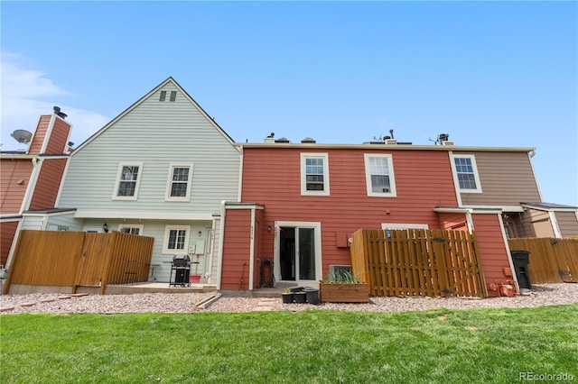 6776 S Independence St, Littleton, CO 80128 - back of property featuring a yard, a patio, and fence