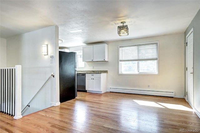 7704 Newland St, Arvada, CO 80003 - kitchen with a baseboard radiator, stainless steel dishwasher, freestanding refrigerator, light wood-style floors, and white cabinets