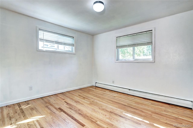 7704 Newland St, Arvada, CO 80003 - unfurnished room featuring baseboard heating and wood finished floors