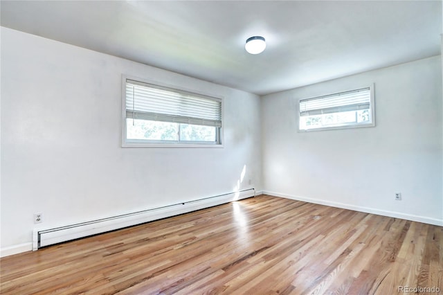 7704 Newland St, Arvada, CO 80003 - empty room with a baseboard radiator and wood finished floors