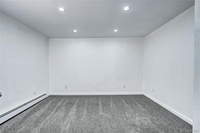 7704 Newland St, Arvada, CO 80003 - spare room with a baseboard heating unit, dark carpet, and recessed lighting