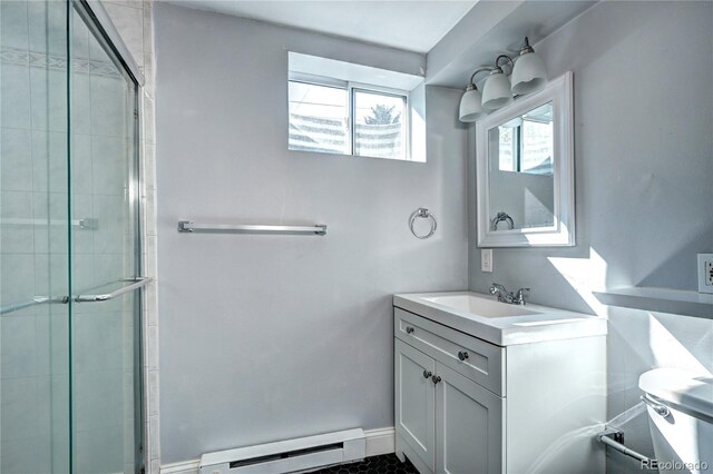 7704 Newland St, Arvada, CO 80003 - full bathroom featuring baseboard heating, a stall shower, and vanity