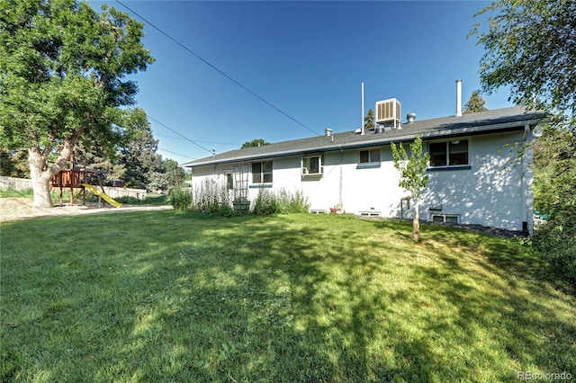 7704 Newland St, Arvada, CO 80003 - back of property featuring a playground and a lawn
