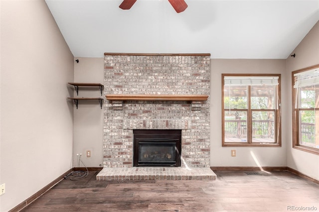 5421 S Vivian St, Littleton, CO 80127 - unfurnished living room with lofted ceiling, ceiling fan, wood finished floors, baseboards, and a brick fireplace