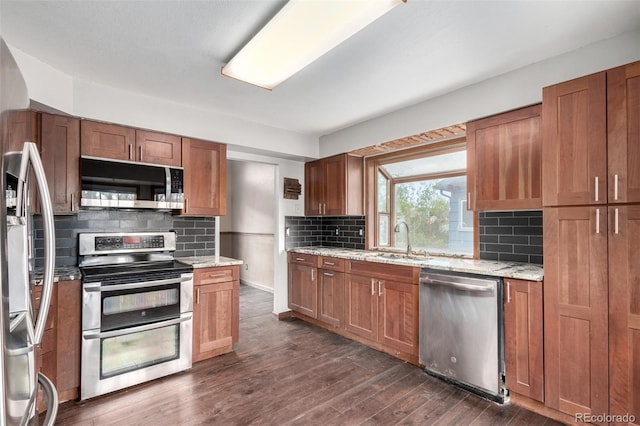 5421 S Vivian St, Littleton, CO 80127 - kitchen featuring stainless steel appliances, a sink, backsplash, and brown cabinets